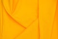 Creased yellow gabardine. Rumpled texture. Folded fabric