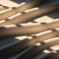Creases and shadows play across a soft, beige fabric, creating a pattern of light and shade. The Royalty Free Stock Photo