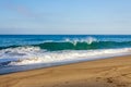 Creasting tourqouise, transparent wave with foam and backspray, backwash, and horizon Royalty Free Stock Photo