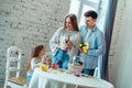 Create an Easter atmosphere together.Loving family tells their daughter about the Easter bunny and traditions of the holiday