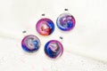 Create galaxy drink coasters using resin, glitter and pigment powders, handmade items. Suitable for keychains, necklace and Royalty Free Stock Photo