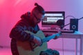 Create music and a recording studio concept - Bearded funny man guitarist recording electric guitar track in home studio