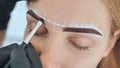 Create permanent eyebrow makeup. Marking the shape of the eyebrows.