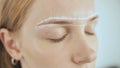 Create permanent eyebrow makeup. Marking the shape of the eyebrows.