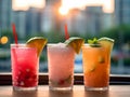 a photo of three juice drinks, watermelon juice, mango juice, and pineapple juice, each in a transparent glass with a straw.Genera