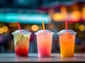 a photo of three juice drinks, watermelon juice, mango juice, and pineapple juice, each in a transparent glass with a straw.Genera