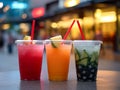 a photo of three juice drinks, watermelon juice, mango juice, and pineapple juice, each in a transparent glass with a straw.Genera