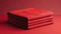 Create a photorealistic image of a stack of four neatly folded red towels on a red table against a red background. The towels