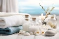 Massage Stones, Essential Oils, and Sea Salt for Spa Procedures on White Wooden Table Royalty Free Stock Photo