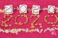 Create 2020 with almonds and flowers on pink background Royalty Free Stock Photo