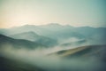 Create a tranquil mountain range with rolling hills, painted in layers of muted green and blue, enveloped by a thin mist Royalty Free Stock Photo