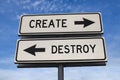 Create versus destroy. White two street signs with arrow on metal pole with words. Directional road. Crossroads Road Sign, Two Royalty Free Stock Photo