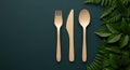 Elegant eco friendly table setting with wooden cutlery and lush green foliage arrangement Royalty Free Stock Photo