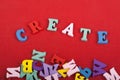 CREATE word on red background composed from colorful abc alphabet block wooden letters, copy space for ad text. Learning english