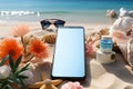 Create your message on a smartphone\'s blank screen amidst beach accessories