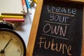 Create your own future on phrase colorful handwritten on chalkboard, alarm clock with motivation and education concepts. Royalty Free Stock Photo