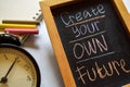 Create your own future on phrase colorful handwritten on chalkboard, alarm clock with motivation and education concepts. Royalty Free Stock Photo