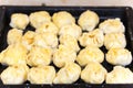 The created buns and pies lie on the oiled baking sheet