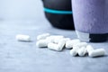 Creatine capsules. Glass of Protein Shake with milk and blueberries and black sporting kettlebell in background. Sport nutrition. Royalty Free Stock Photo