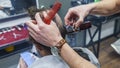 Creating a close-up of a mans haircut, a hairdresser cuts his hair with a haircut and a comb