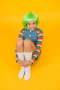 Creating fancy look. Happy child with slick look of green hair wig. Beauty look of small fashion model. Just gorgeous