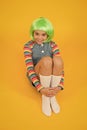Creating fancy look. Happy child with slick look of green hair wig. Beauty look of small fashion model. Just gorgeous