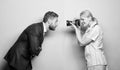 Creating a fashion look. Fashion shooting in photo studio. Businessman posing in front of female photographer Royalty Free Stock Photo