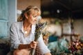 Creating a festive bouquet of dried flowers in the country. Woman florist makes with her hands a beautiful arrangement of flowers