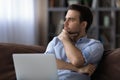 Contemplative young man distracted from laptop ponder on project solution Royalty Free Stock Photo