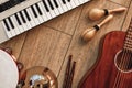 Creating a melody...Top view of musical instruments set: synthesizer, electronic guitar, wooden drum sticks, golden Royalty Free Stock Photo