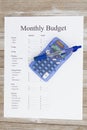 Creating a monthly budget with pen and calculator