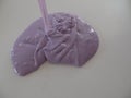 Creating patterns out of lilac coloured glossy slime
