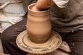 Creating a pot of clay close-up. Hands making products from clay. Potter at work