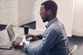 Creating some designs. a handsome young male architect working on a laptop in a modern office.