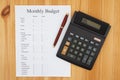 Creating your monthly budget with a calculator and pen