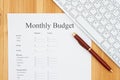 Creating your monthly budget online and a pen with a keyboard