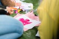 Creating your own t-shirt workshop. Young woman hand painting on t shirt