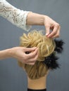 Creation of a hairstyle on a mannequin. Royalty Free Stock Photo