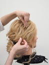 Creation of a hairstyle on a mannequin. Royalty Free Stock Photo
