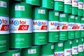 Group of stacked barrels with motor oil lubricant in warehouse