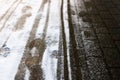 Creative abstract background from the set of traces of human foot prints and the wheels of baby carriage in the snow