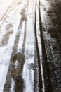 Creative abstract background from the set of traces of human foot prints and the wheels of baby carriage in the snow