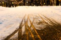 Creative abstract background from the set of traces of human foot prints and the wheels of baby carriage in the snow