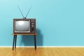 Old retro TV against blue vintage wall in the room Royalty Free Stock Photo
