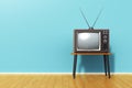 Old retro TV against blue vintage wall in the room Royalty Free Stock Photo