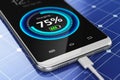 Smartphone charging with solar panel charger Royalty Free Stock Photo