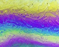 A creative abstract swirling liquid rainbow of colours that looks like watercolour paints or inks