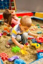 Creative activities for kids. Happy kids playing in sandbox outdoors