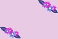Creative arrangement of colorful flowers on purple background.