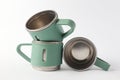 Creative Arrangement of Green Metal Mugs on White Background Royalty Free Stock Photo